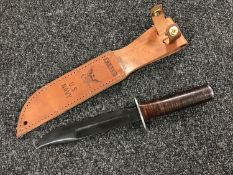 A Bowie type knife in sheath stamped US Navy