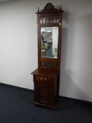A mahogany mirrored hall stand fitted with a cupboard