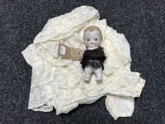 A child's Victorian christening dress and an antique bisque headed doll