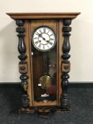 A mahogany wall clock with pendulum and key