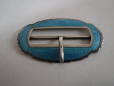 A silver and enamel belt buckle