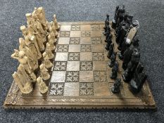 A chess set on carved board