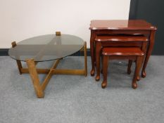 A mid 20th century teak smoked glass topped table and a nest of tables