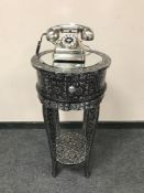 A contemporary silvered telephone table with mirrored top together with vintage style telephone.