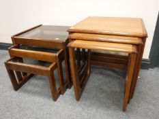 A nest of three teak Sun Elm tables and a nest of glass topped tables