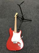 A Westfield electric guitar together with a guitar stand