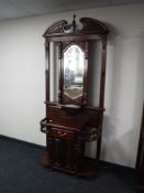 A mahogany mirrored hall stand fitted cupboard and drawer