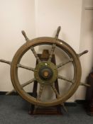 A large antique ship's wheel mounted on stand