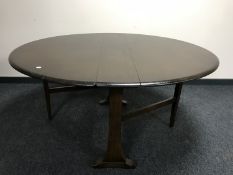 A narrow Ercol elm drop leaf table