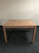 A contemporary rectangular extending table with leaf and an entertainment stand