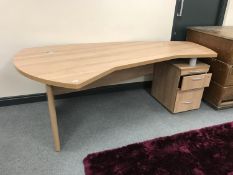 A shaped office desk with pedestal and keys