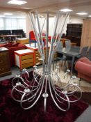 A bespoke twelve branch metal light fitting,