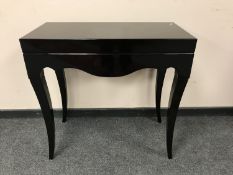 A contemporary black console table,