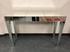 A contemporary mirrored hall table,
