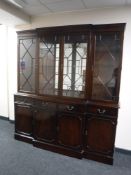 A reproduction mahogany four door break-front bookcase