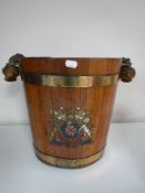 An oak brass bound bucket bearing military crest