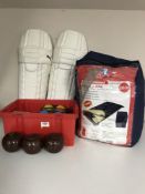 A box containing carpet bowls, French boules,