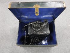 A tin trunk containing an Aldis lamp in box