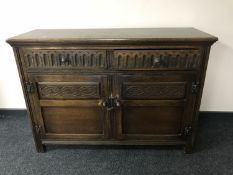 A carved oak double door sideboard