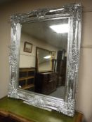A very ornate gilded overmantel mirror,
