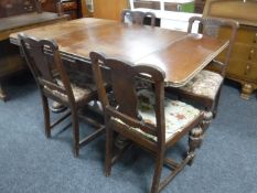 A carved oak extending dining table and four chairs
