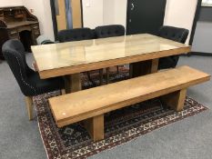 A contemporary 6'6'' hardwood dining table together with matching low bench and four buttoned