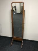 A Victorian walnut framed cheval mirror