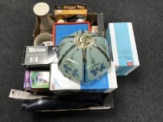 Two boxes containing candle holders, alarm clocks, cool box, wheel trims,