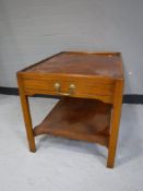 An inlaid yew wood two tier coffee table