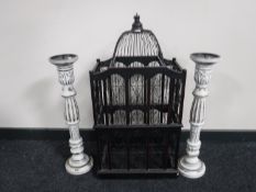 An Eastern style bird cage and a pair of shabby chic candle holders