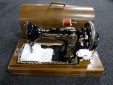 A cased Frister & Rossmann hand sewing machine
