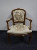 A carved walnut framed salon armchair