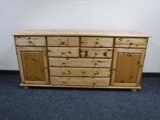 A contemporary pine sideboard fitted nine drawers