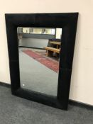 A contemporary cushion framed mirror,