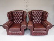 A pair of button leather Chesterfield wing back armchairs