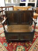 An Edwardian oak hall seat