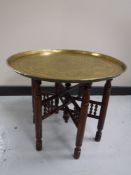 A folding Eastern brass topped table