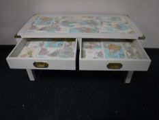 A painted and brass mounted coffee table depicting a map of the world