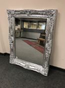 An ornate silvered mirror,
