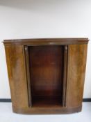 An early 20th century mahogany and walnut bookcase fitted cabinets either side