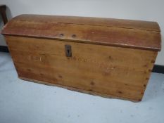 An antique pine dome topped shipping trunk