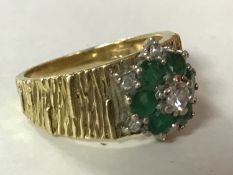 An 18ct gold emerald and diamond cluster ring, size L.