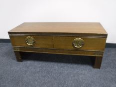 An oak oriental style low table fitted two drawers