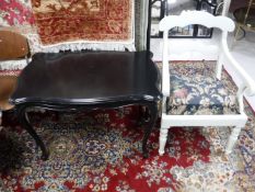 An early 20th century painted armchair and a painted French table