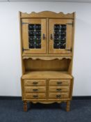 A blonde oak double door cabinet fitted six drawers beneath