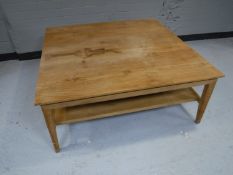 A contemporary pine square coffee table