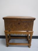 A 19th century carved oak bible box on stand