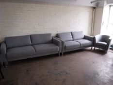 A three piece lounge suite in grey fabric