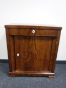A late 19th century mahogany cupboard fitted a drawer