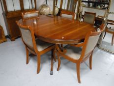 An inlaid yew wood six piece dining room suite